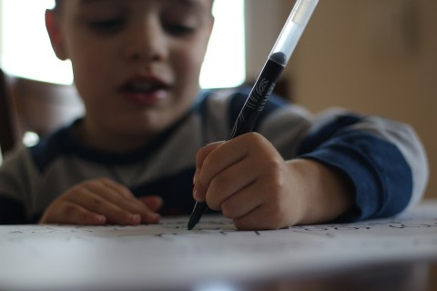 Boy writing AshTutors.co.uk